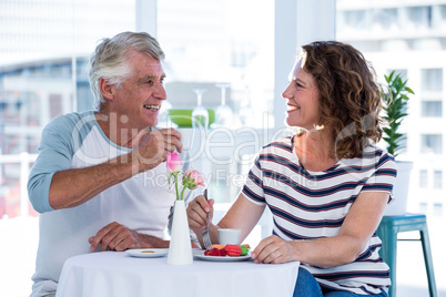 Happy couple interacting at restaurant