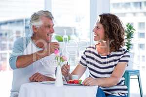 Happy couple interacting at restaurant