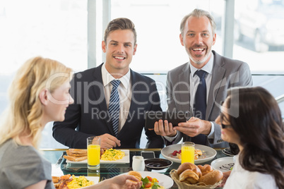 Business people having meal in restaurant