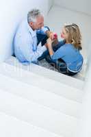 High angle view of mature man giving rose to woman