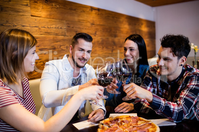 Friends toasting wine at table