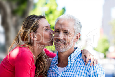 Romantic mature woman kissing man