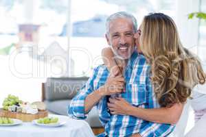 Woman kissing husband in restaurant