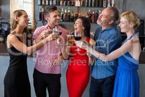 Group of friends toasting glasses of beer and wine