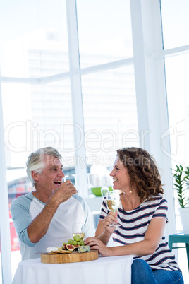 Mature couple enjoying champagne at restaurant