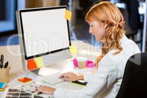 Female photo editor working at computer desk