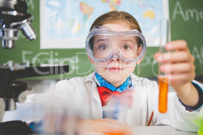 Schoolgirl doing a chemical experiment in laboratory