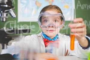 Schoolgirl doing a chemical experiment in laboratory