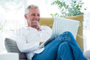 Smiling mature man using laptop