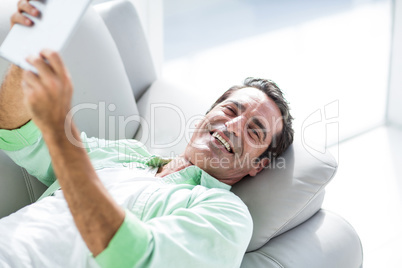 Man holding digital tablet at home