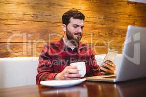 Man using mobile phone in restaurant