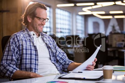 Businessman reading documents at desk