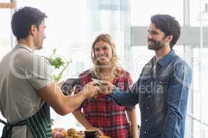 Couple paying bill at coffee shop using card bill