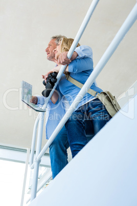 Thoughtful mature couple by railing at home