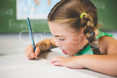 Schoolgirl doing homework in classroom