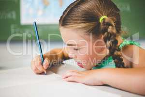 Schoolgirl doing homework in classroom