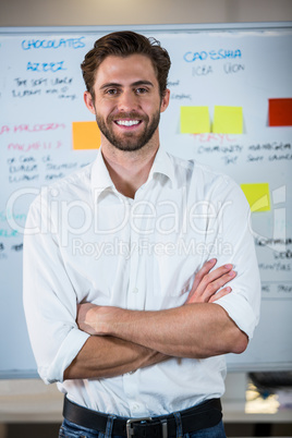 Confident businessman against whiteboard in office