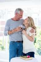 Romantic smiling mature couple with red wine