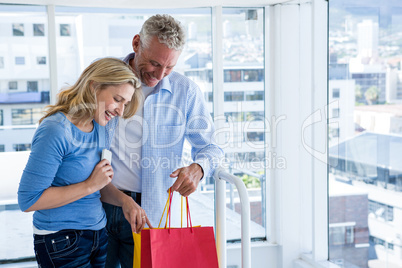 Couple looking at shopping bags at home