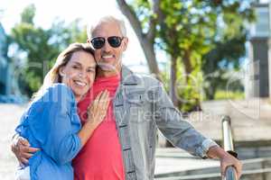 Smiling mature couple standing on footpath