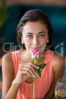 Portrait of smiling woman smelling a rose