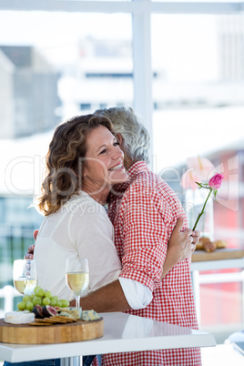 Couple hugging at restaurant