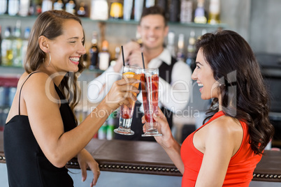 Beautiful women toasting cocktail glasses