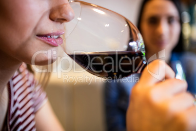 Cropped image of woman drinking wine