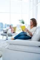 Smiling mature woman reading book with man