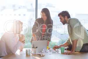 Creative colleagues discussing at desk