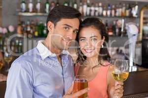 Portrait of romantic couple holding wine glasses