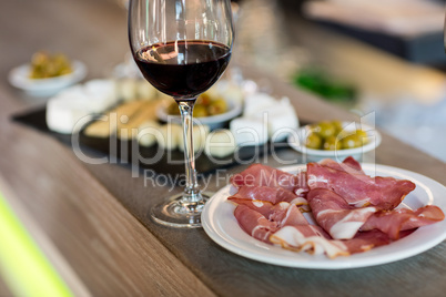 Meat and wineglass on table at restaurant