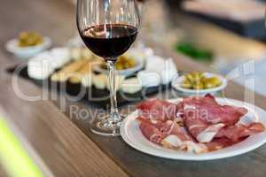 Meat and wineglass on table at restaurant
