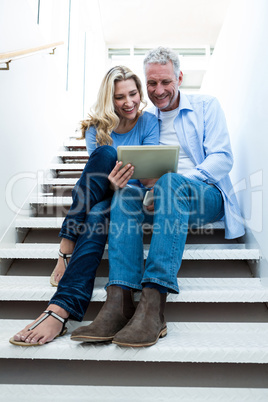 Full length of couple using digital tablet