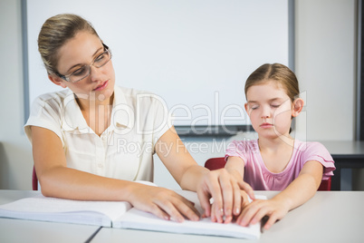 Teacher assisting blind student in library