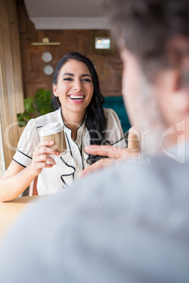 Couple interacting with each other in cafeteria