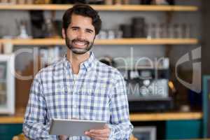 Portrait of smiling man using digital tablet