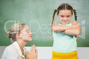 Female teacher apologizing girl in the classroom