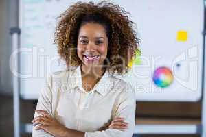 Portrait of woman standing against whiteboard