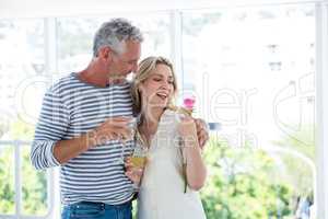 Romantic mature couple with wine glasses and rose