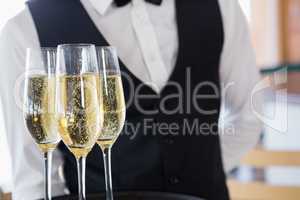 Waiter holding glasses of champagne