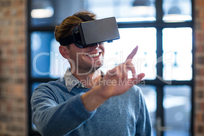 Businessman using virtual reality headset in office