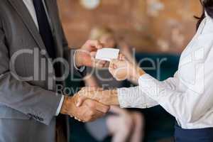 Business colleagues exchanging business card