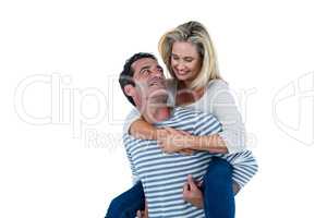 Romantic man carrying woman piggyback