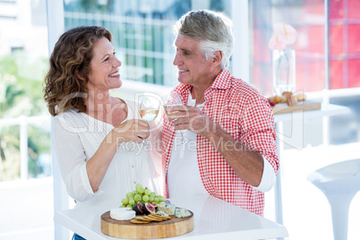 Smiling couple toasting champagne at restaurant