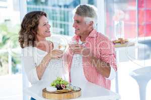 Smiling couple toasting champagne at restaurant
