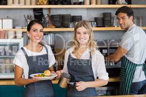 Portrait of smiling colleague working at counter