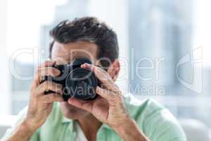 Man using camera at home