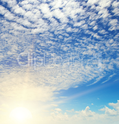 sun on blue sky with white clouds