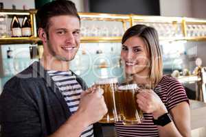 Portrait of couple toasting beer mug